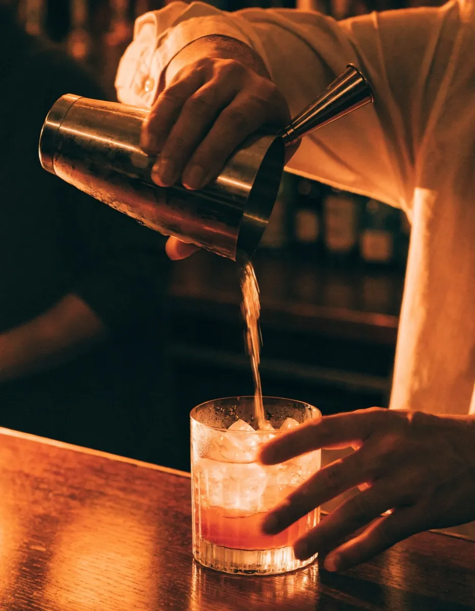 Bartender pouring a drink at Bar Fredo